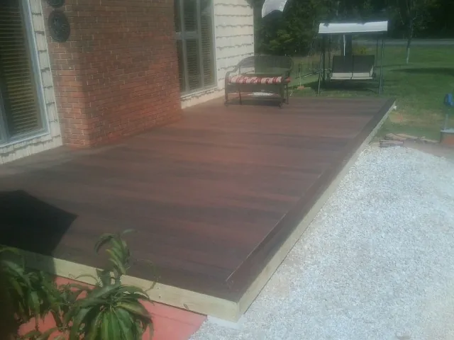 Freshly stained wood deck built against a brick home in Crown Point